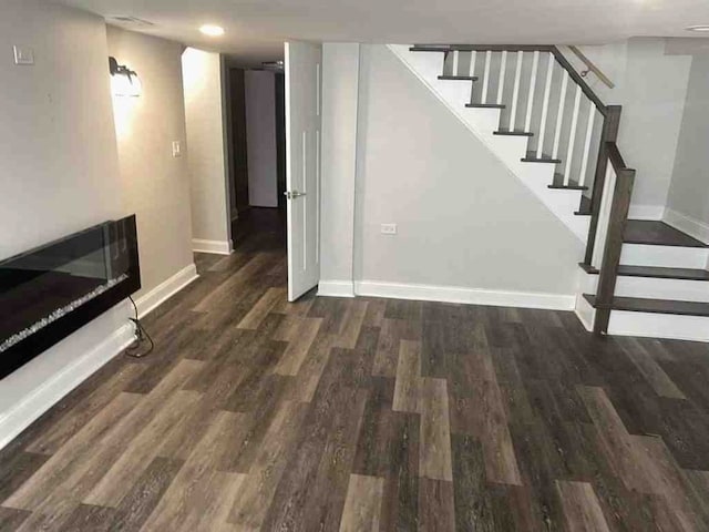 basement featuring dark hardwood / wood-style floors