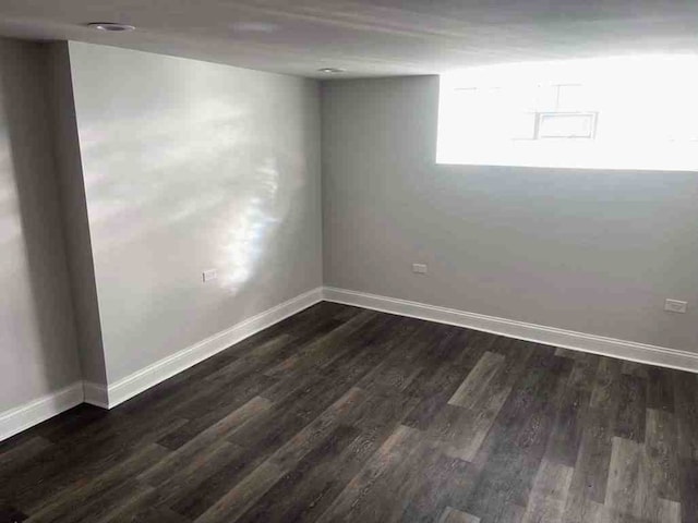 spare room with dark hardwood / wood-style flooring