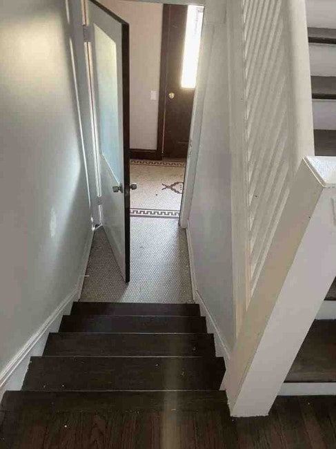 stairway with dark tile floors