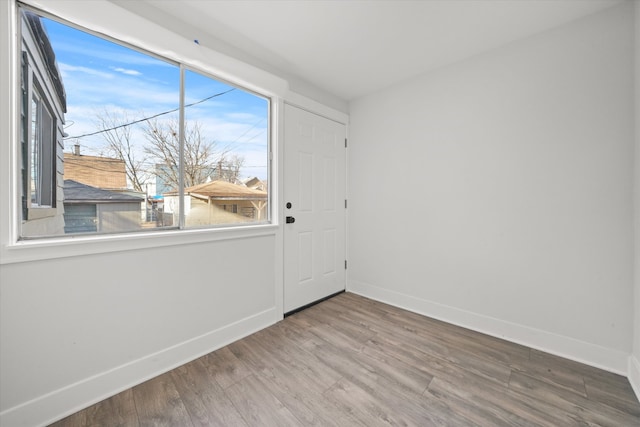 spare room featuring hardwood / wood-style flooring and plenty of natural light