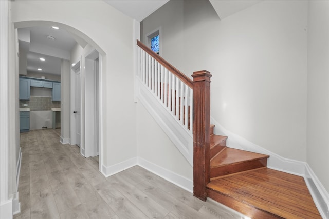 staircase featuring light hardwood / wood-style flooring