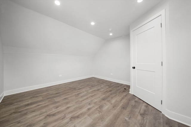 bonus room featuring hardwood / wood-style floors and vaulted ceiling