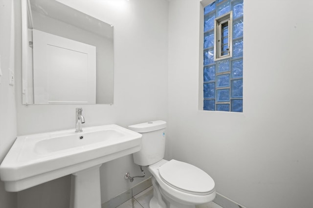 bathroom with sink, tile floors, and toilet