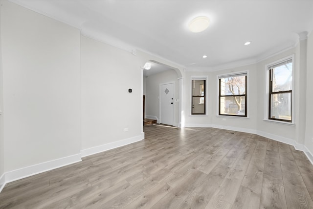 unfurnished room with crown molding and light hardwood / wood-style flooring