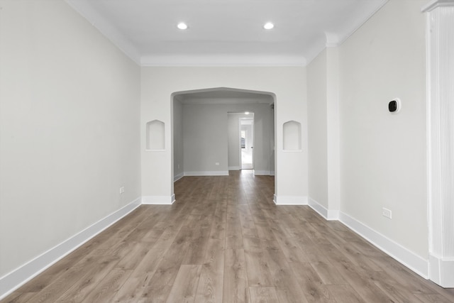 unfurnished room featuring ornamental molding and wood-type flooring