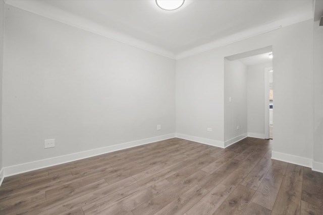 unfurnished room featuring crown molding and dark hardwood / wood-style flooring