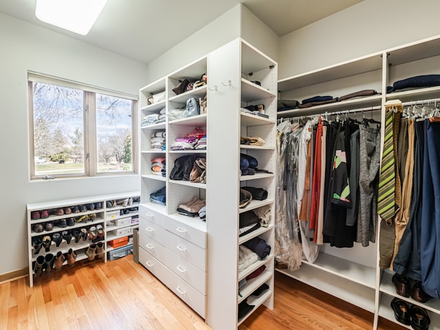 spacious closet with light hardwood / wood-style floors