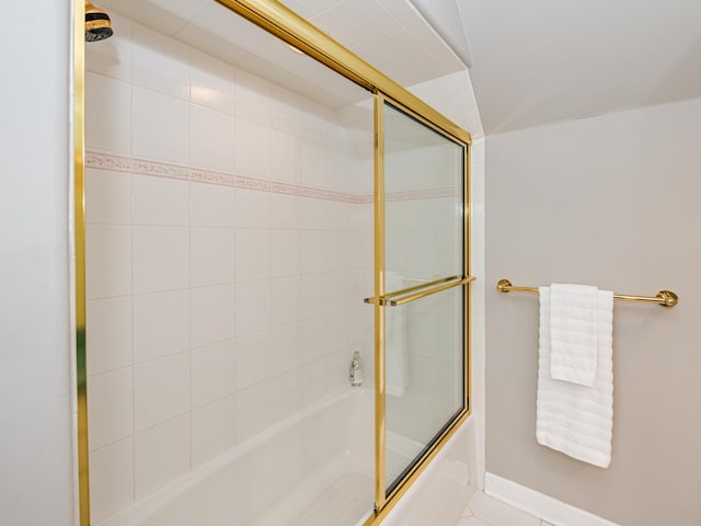 bathroom featuring combined bath / shower with glass door