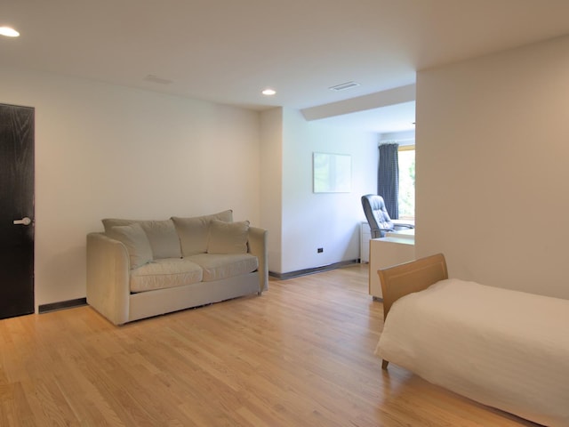 living room featuring radiator and light hardwood / wood-style floors