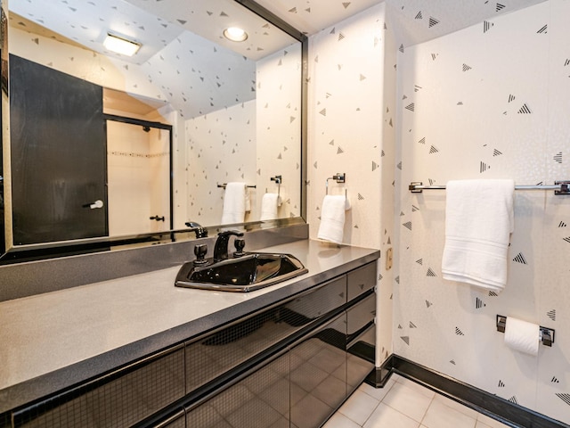 bathroom featuring lofted ceiling, tile patterned flooring, and vanity