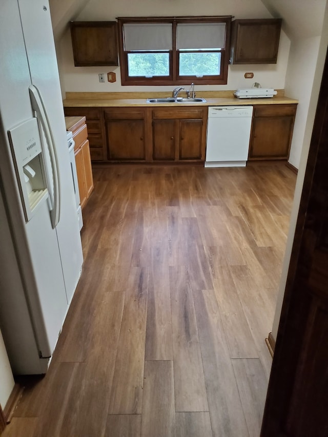 kitchen featuring sink, white appliances, and light hardwood / wood-style floors