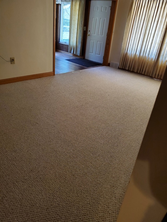 spare room featuring dark colored carpet