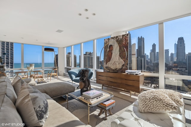 living room featuring floor to ceiling windows and a water view