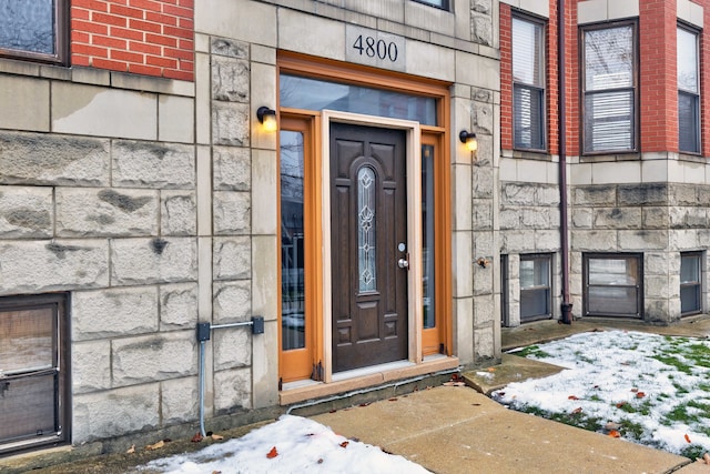 view of snow covered property entrance