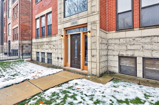 view of snow covered property entrance