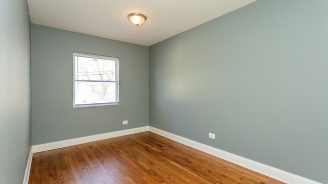 empty room with dark hardwood / wood-style floors