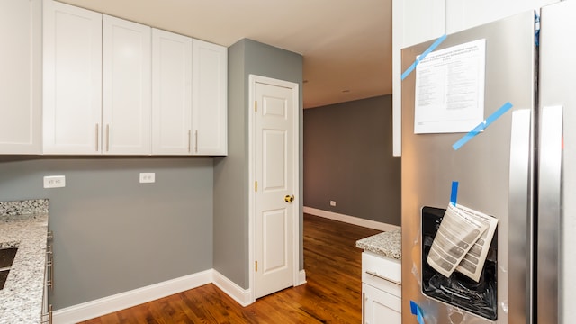 kitchen featuring white cabinets, stainless steel fridge, dark hardwood / wood-style floors, and light stone countertops