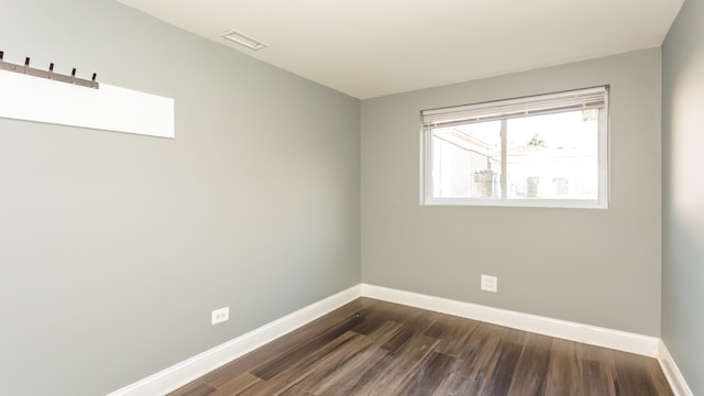 unfurnished room featuring dark wood-type flooring