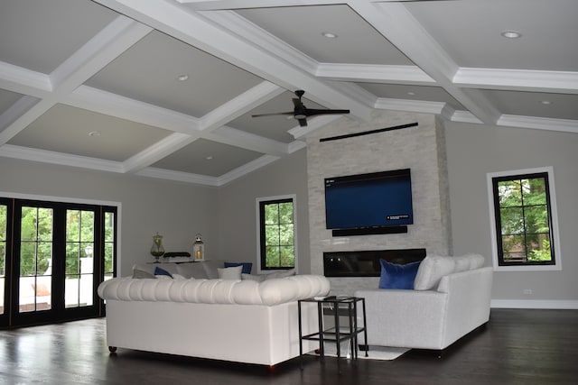 living room with lofted ceiling with beams, plenty of natural light, dark wood-type flooring, and a fireplace