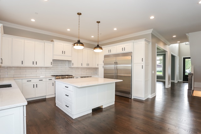 kitchen featuring a center island, white cabinetry, dark hardwood / wood-style floors, and built in fridge