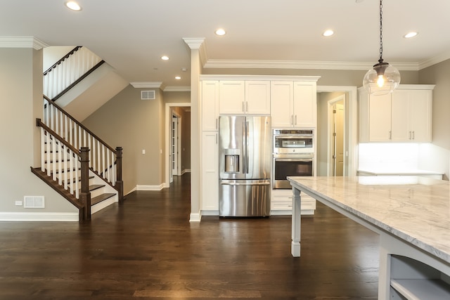 kitchen featuring decorative light fixtures, light stone countertops, dark hardwood / wood-style flooring, white cabinetry, and appliances with stainless steel finishes