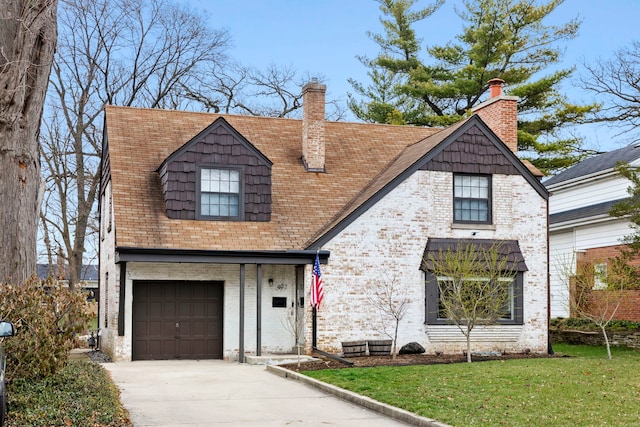 view of front facade featuring a garage, a front lawn, concrete driveway, and brick siding