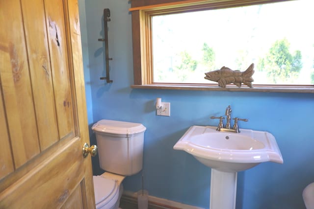 bathroom featuring plenty of natural light and toilet