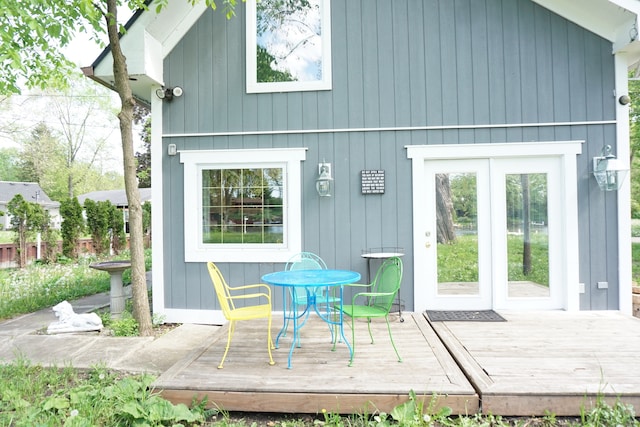 back of property featuring a wooden deck and french doors