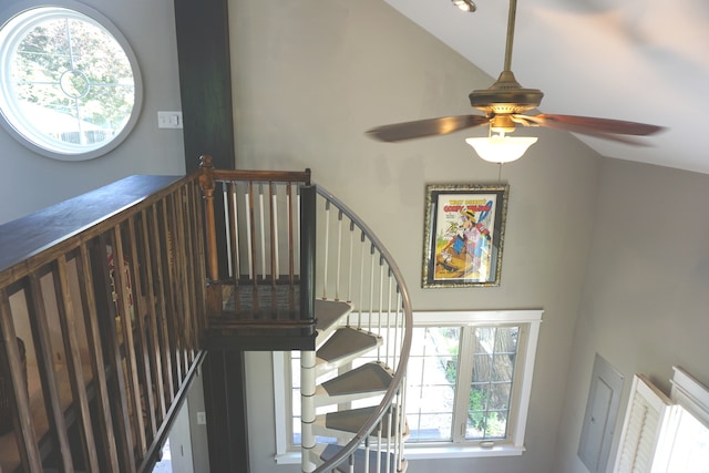 staircase featuring high vaulted ceiling