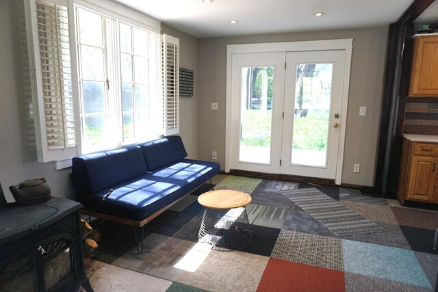 living room with a healthy amount of sunlight and a wood stove