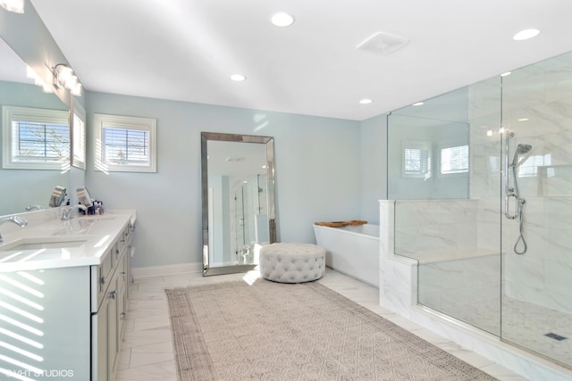 bathroom with double sink vanity, shower with separate bathtub, and tile floors