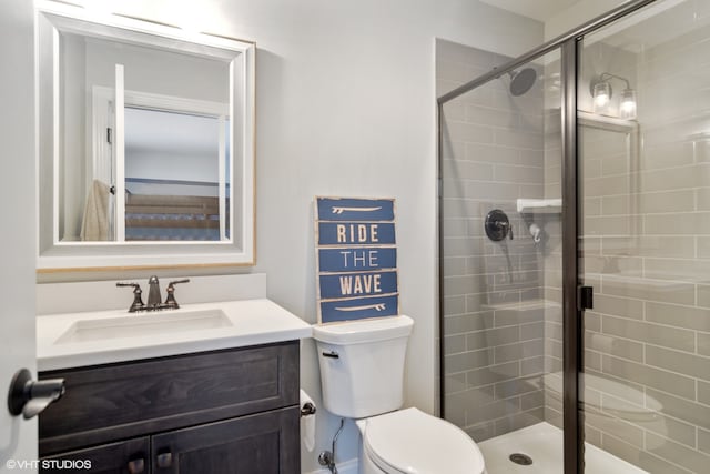 bathroom with walk in shower, toilet, and large vanity