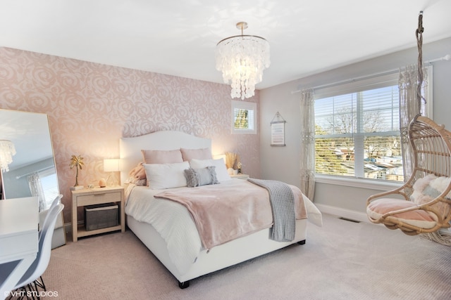 bedroom with light carpet and a chandelier