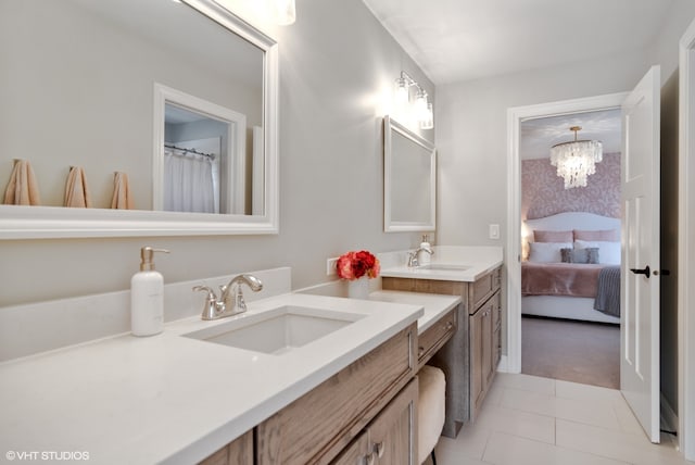 bathroom featuring an inviting chandelier, double vanity, and tile floors