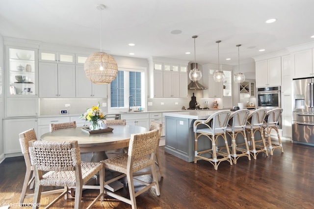 dining area featuring sink and dark wood-type flooring