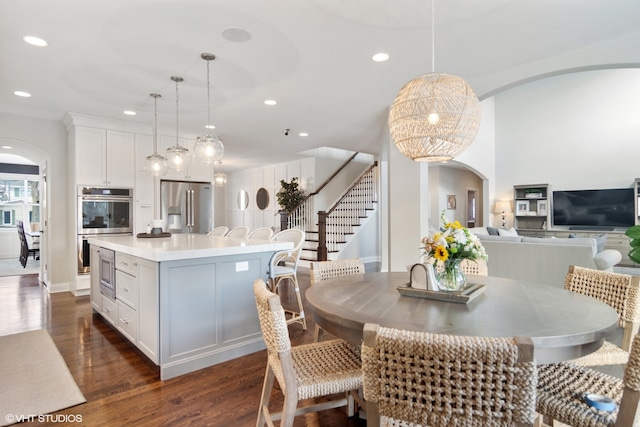 dining space with dark wood-type flooring