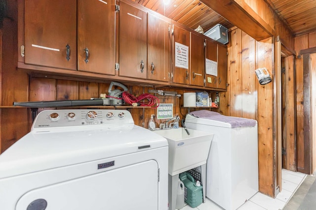 laundry area featuring wood ceiling, washer / clothes dryer, cabinet space, and wooden walls