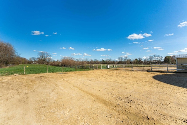 view of yard featuring a rural view and an enclosed area