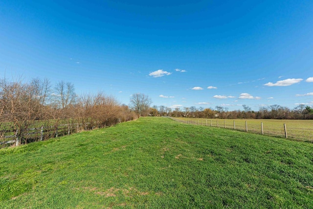 view of yard featuring a rural view and fence