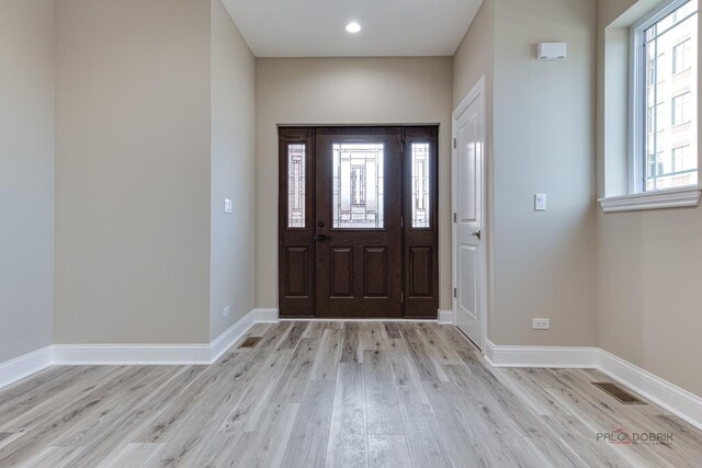 180 N E River Rd Unit E, Des Plaines, IL 60016 - foyer entrance featuring baseboards, light wood-style flooring, and visible vents