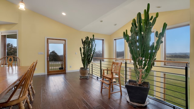 dining area featuring dark hardwood / wood-style flooring and vaulted ceiling