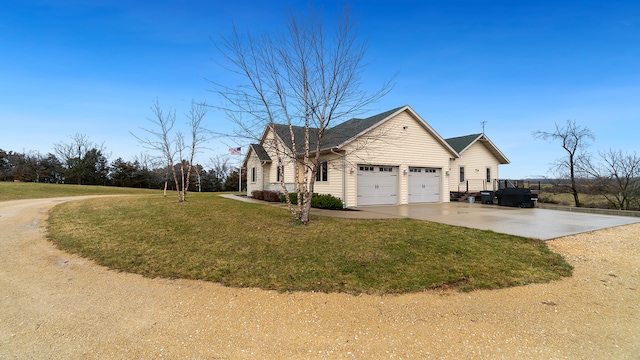 view of front of property with a front yard and a garage