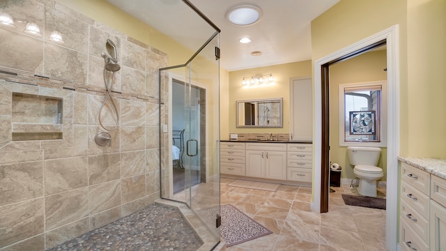 bathroom featuring walk in shower, tile floors, toilet, and vanity