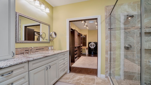 bathroom featuring walk in shower, vanity, and tile floors