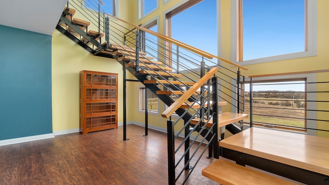 staircase with dark wood-type flooring