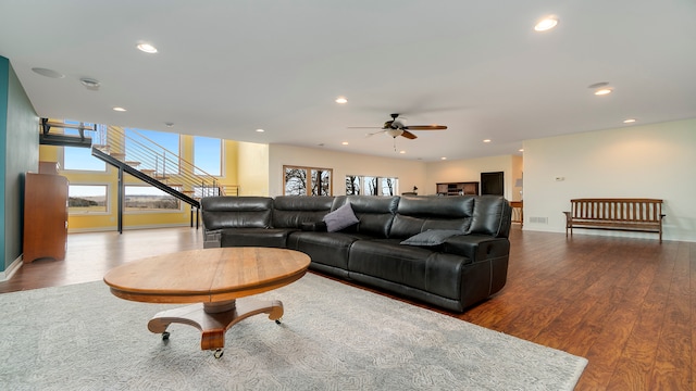 living room featuring light hardwood / wood-style floors and ceiling fan