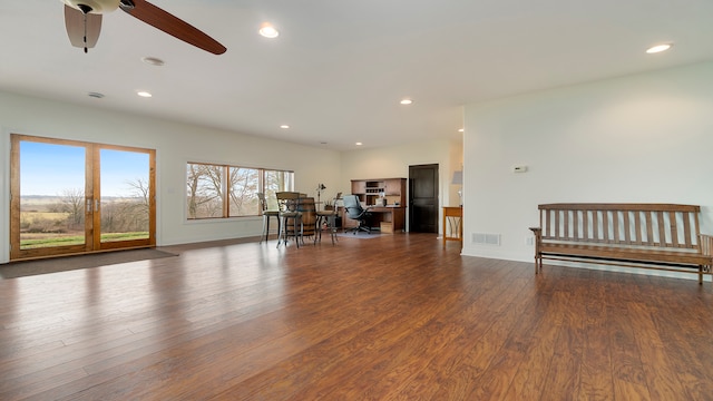 living room with dark hardwood / wood-style flooring and ceiling fan