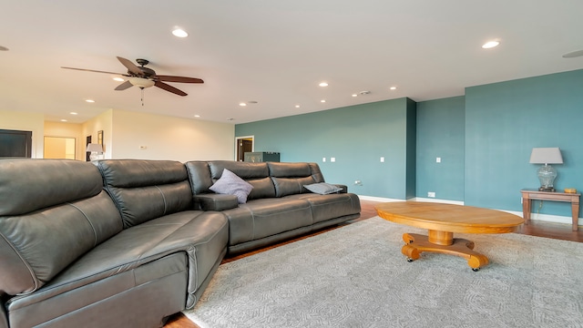 living room with light hardwood / wood-style floors and ceiling fan