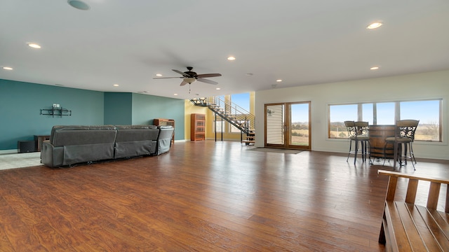 living room featuring dark hardwood / wood-style floors and ceiling fan