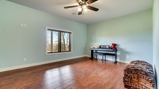 miscellaneous room featuring ceiling fan and dark hardwood / wood-style floors